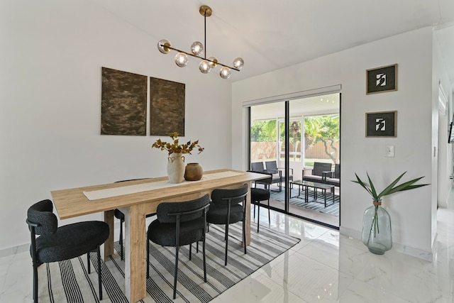 dining area with an inviting chandelier