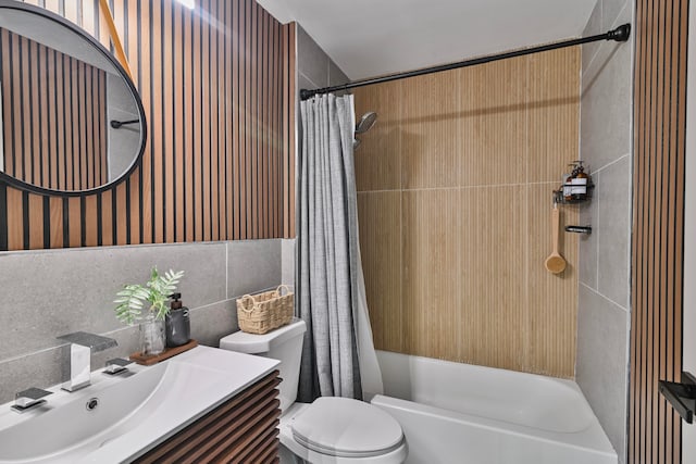 full bathroom with shower / bath combo, toilet, tile walls, vanity, and decorative backsplash