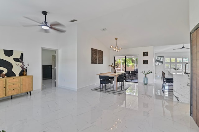 dining space featuring a chandelier and high vaulted ceiling