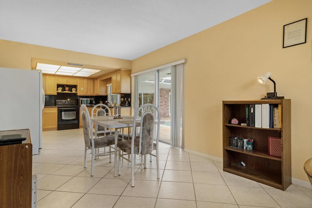 dining area featuring light tile patterned floors