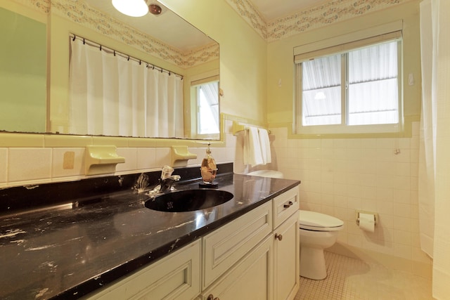 bathroom featuring tile walls, tile patterned floors, vanity, and toilet