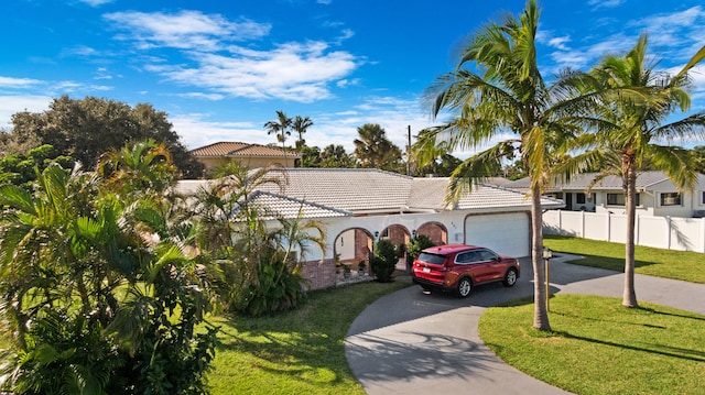 view of front facade featuring a garage and a front lawn