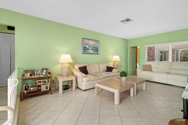 living room with light tile patterned floors and a textured ceiling