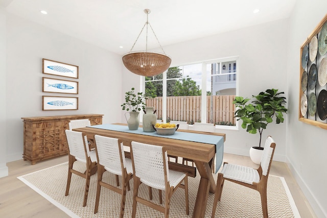 dining room with recessed lighting, baseboards, and light wood-style flooring