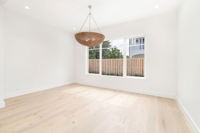 unfurnished room with recessed lighting, baseboards, and wood finished floors