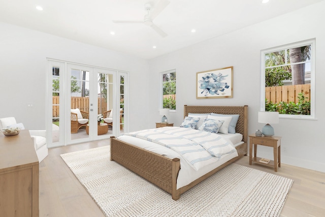 bedroom featuring light hardwood / wood-style floors, multiple windows, access to exterior, and ceiling fan