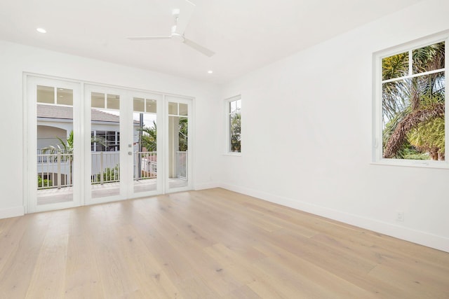 unfurnished room with french doors, light hardwood / wood-style floors, and ceiling fan