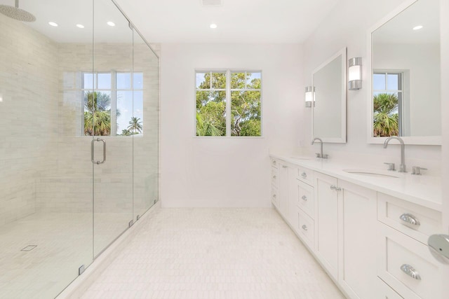 bathroom with a sink, a shower stall, and recessed lighting