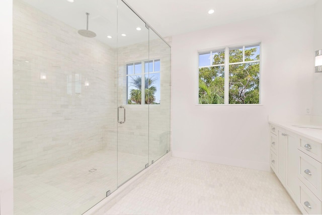 bathroom with a shower with door and vanity