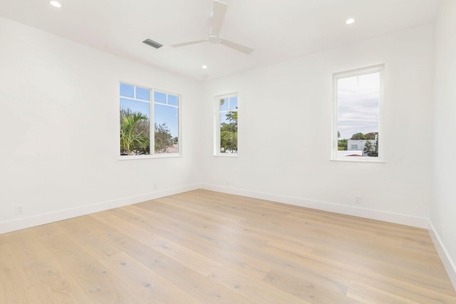 unfurnished room with ceiling fan and light wood-type flooring