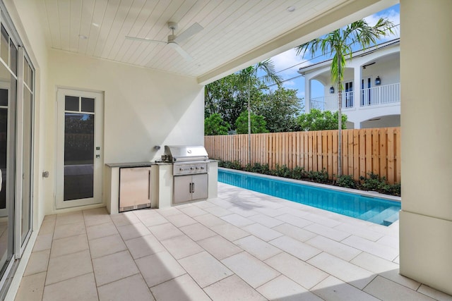 view of pool with fence, grilling area, area for grilling, a ceiling fan, and a patio area