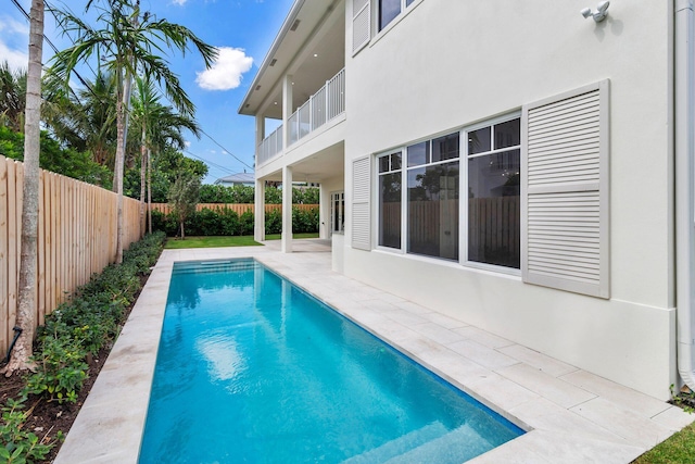 view of swimming pool with a fenced backyard, a fenced in pool, and a patio area