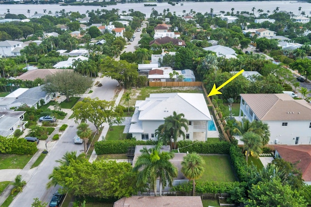 drone / aerial view with a water view and a residential view