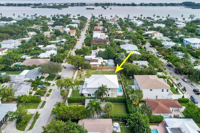 birds eye view of property with a water view and a residential view
