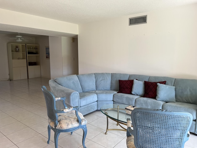10915 Palm Lake Ave Unit 102, Boynton Beach, FL 33437 - living room with a textured ceiling, visible vents, light tile patterned floors, and a ceiling fan