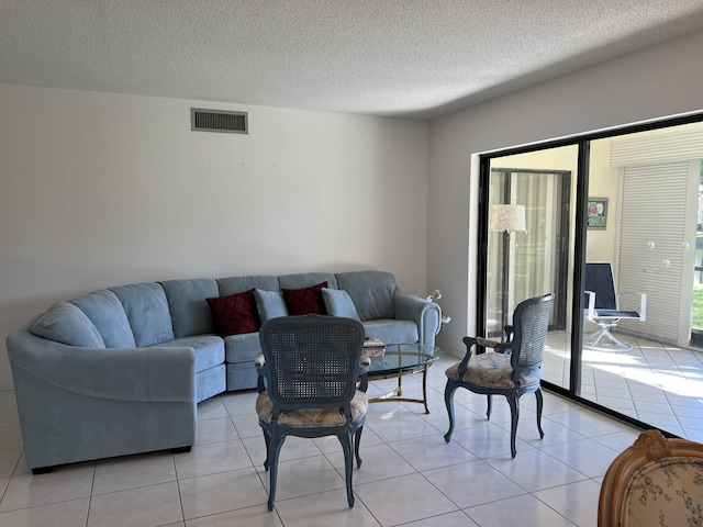 10915 Palm Lake Ave Unit 102, Boynton Beach, FL 33437 - living room featuring a textured ceiling, visible vents, and light tile patterned floors