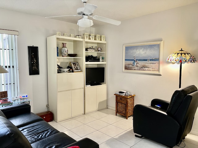 tiled living room featuring ceiling fan