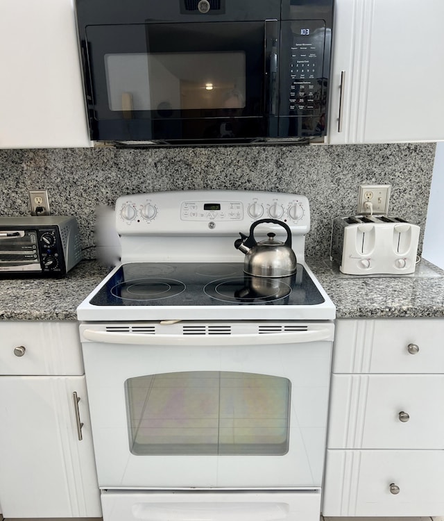 kitchen with decorative backsplash, white cabinets, and white electric range oven