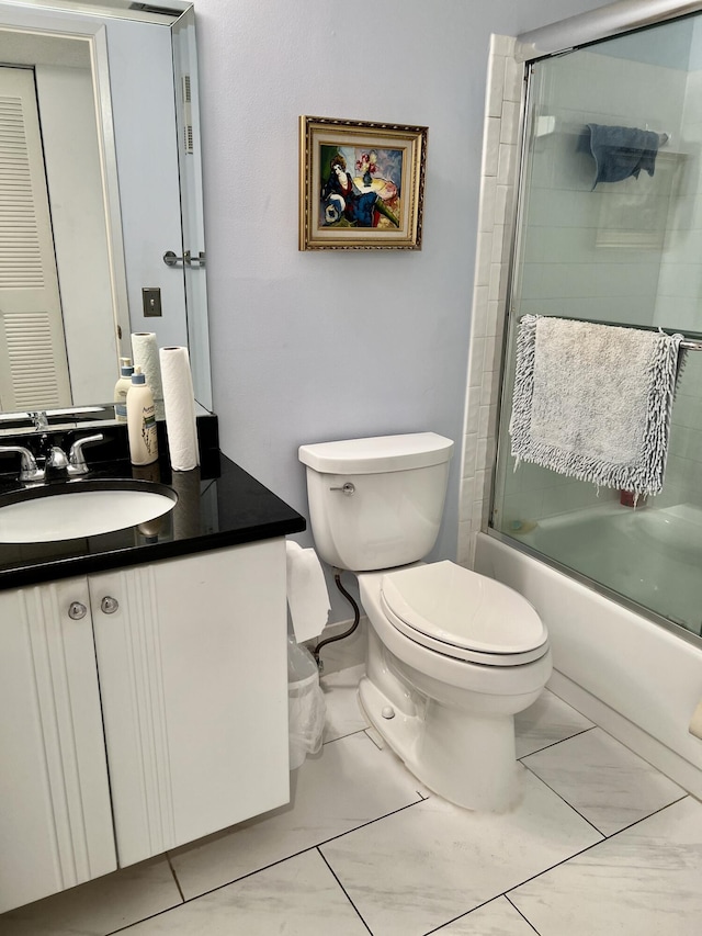 bathroom with marble finish floor, shower / bath combination with glass door, vanity, and toilet