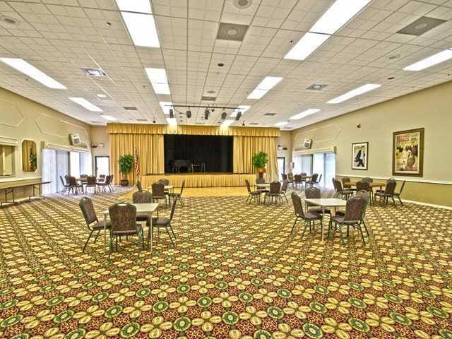 carpeted dining room with a drop ceiling, rail lighting, and baseboards