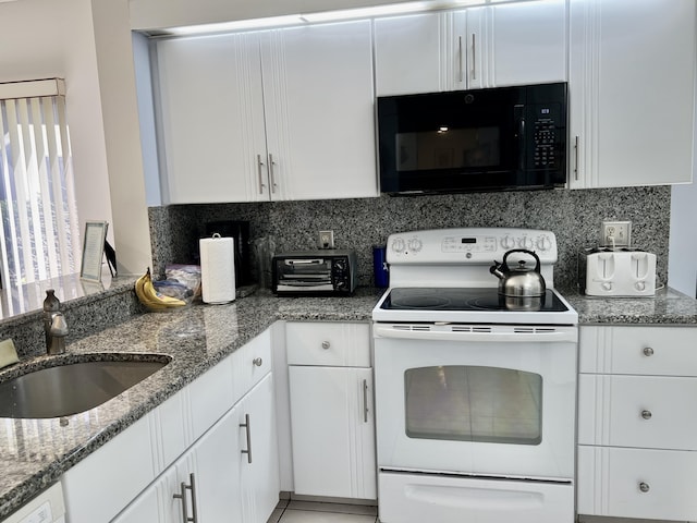 kitchen with white appliances, white cabinets, a sink, and decorative backsplash