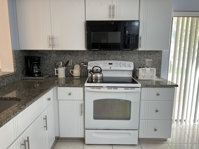 10915 Palm Lake Ave Unit 102, Boynton Beach, FL 33437 - kitchen with white electric range oven, decorative backsplash, dark stone countertops, black microwave, and light tile patterned floors