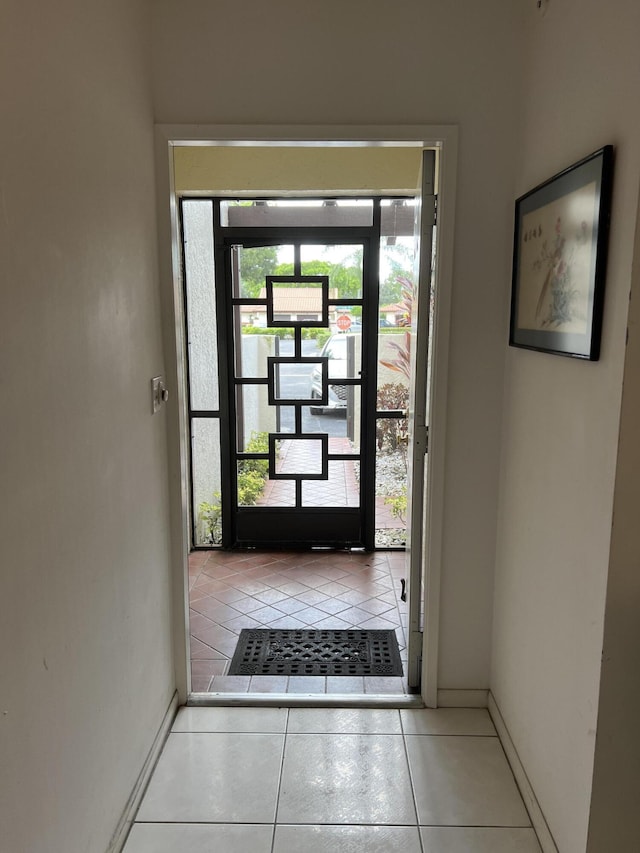 doorway to outside with tile patterned floors