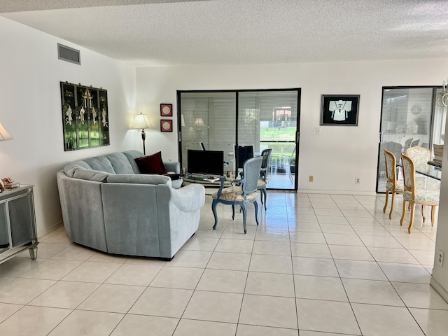 living room with light tile patterned flooring and a textured ceiling