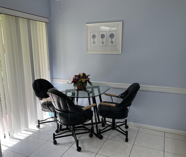 dining area featuring light tile patterned floors and baseboards