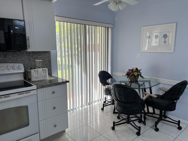 10915 Palm Lake Ave Unit 102, Boynton Beach, FL 33437 - kitchen with black microwave, electric range, backsplash, and light tile patterned floors