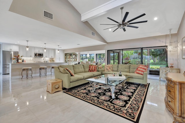 living room featuring beamed ceiling, high vaulted ceiling, and ceiling fan