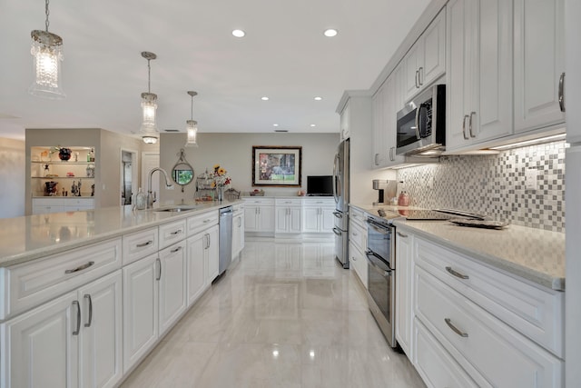 kitchen with appliances with stainless steel finishes, white cabinets, and sink