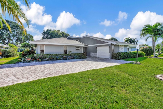 ranch-style home with a front yard and a garage