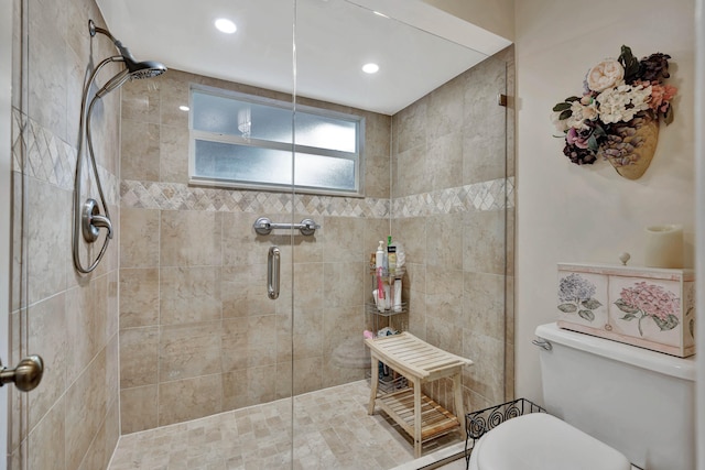 bathroom featuring toilet and an enclosed shower