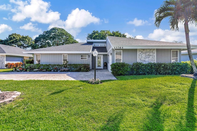 ranch-style house with a front lawn