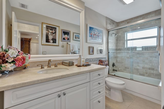 full bathroom with toilet, enclosed tub / shower combo, vanity, and tile patterned floors