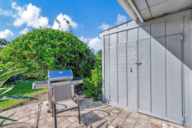 view of patio with a storage unit and area for grilling