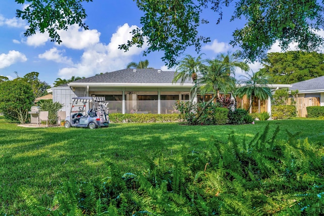 rear view of property featuring a yard