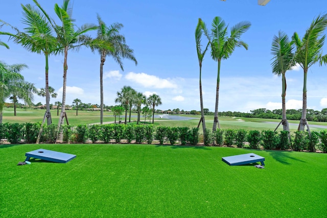 view of home's community featuring a yard and a water view