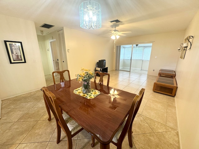 tiled dining area with ceiling fan with notable chandelier