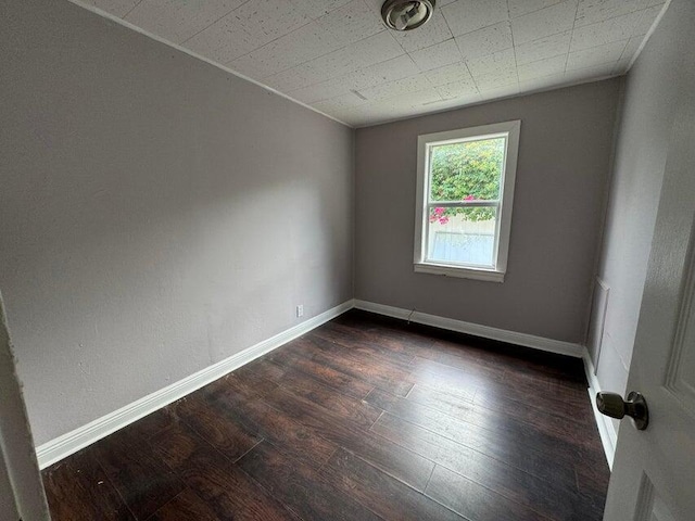 empty room with dark wood-type flooring