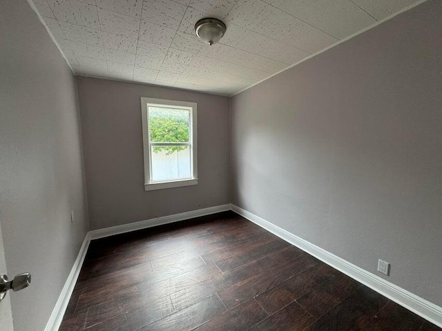 unfurnished room with dark hardwood / wood-style floors