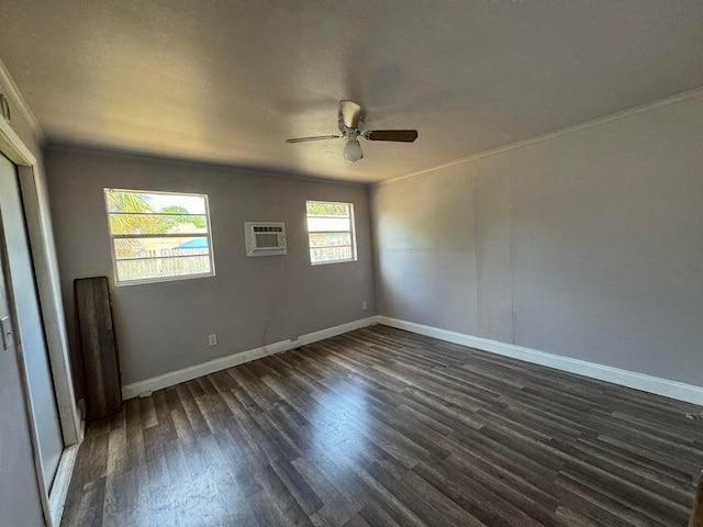 empty room featuring an AC wall unit, crown molding, ceiling fan, and dark hardwood / wood-style flooring