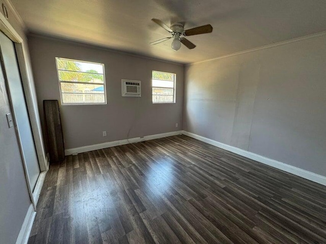 empty room featuring ceiling fan, plenty of natural light, dark hardwood / wood-style floors, and a wall mounted AC