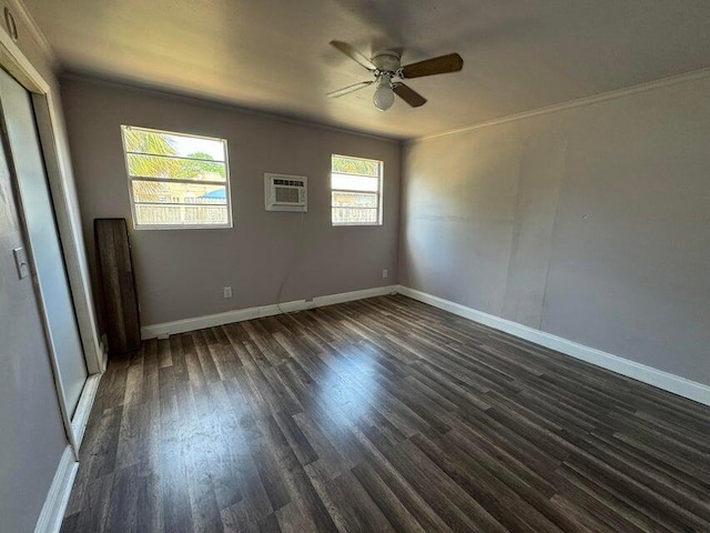 spare room with ceiling fan, an AC wall unit, ornamental molding, and dark wood-type flooring