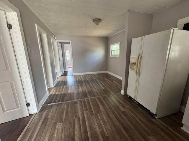 kitchen featuring white refrigerator with ice dispenser and dark hardwood / wood-style floors