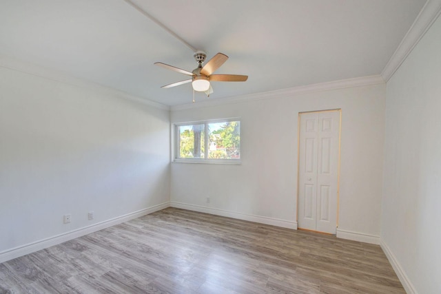 unfurnished room with light hardwood / wood-style floors, crown molding, and ceiling fan