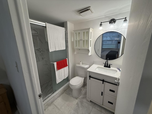 bathroom with vanity, toilet, and a shower with door