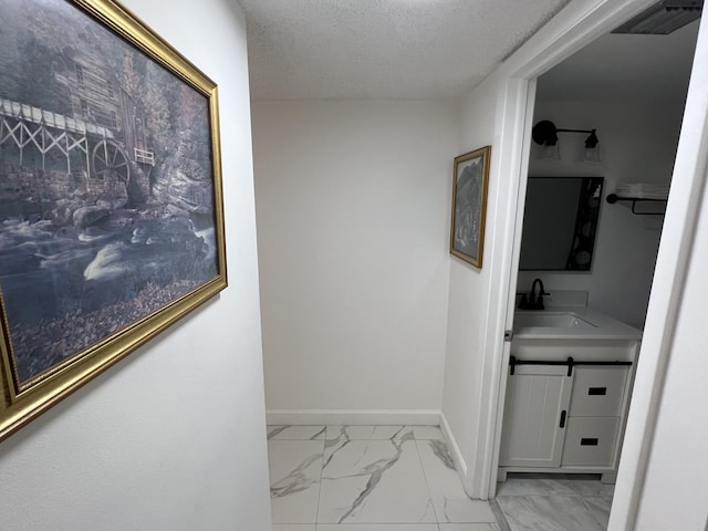 bathroom with vanity and a textured ceiling