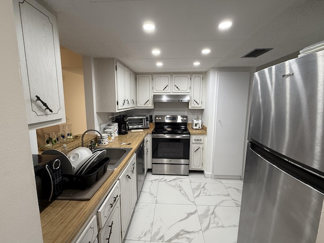 kitchen featuring butcher block countertops, sink, and black appliances